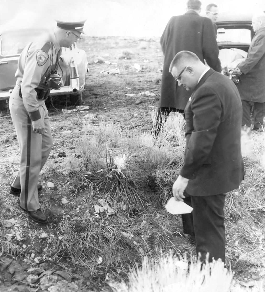 Investigators peruse the scene where the bodies of Marjorie and Nancy McQuiston were found